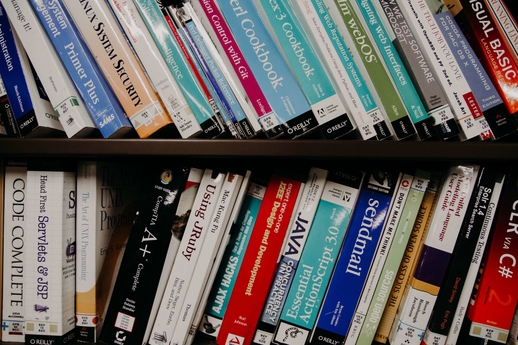 Tech books on a bookshelf